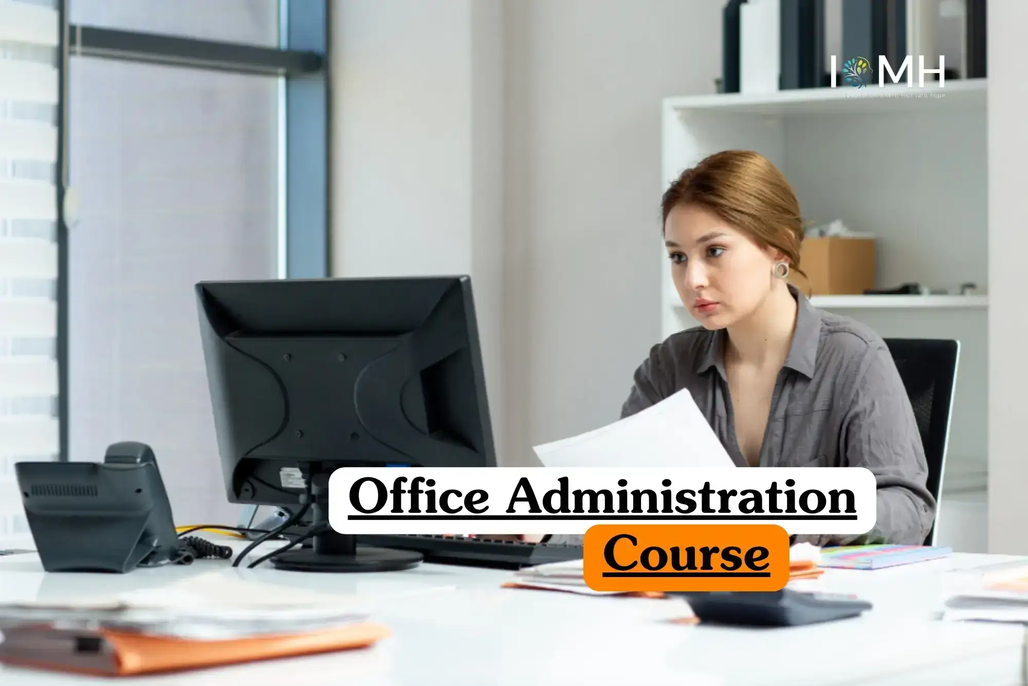 Office Administration course banner with professional working at desk computer surrounded by office supplies.
