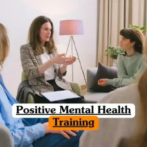 Positive Mental Health Training course banner with group of people sitting in comfortable indoor setting engaged in supportive discussion one person leading conversation gesturing with hands while others listen attentively background with lamp plant and curtains professional mental health education environment.