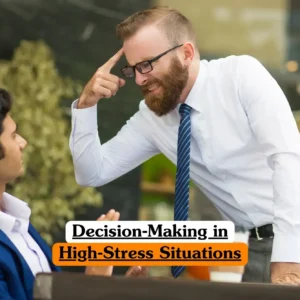 Decision-Making in High-Stress Situations course banner with two professionals in business setting one in white shirt and blue striped tie emphasizing point by gesturing to temple while other in blue suit listens attentively with coffee cups on table and greenery background.