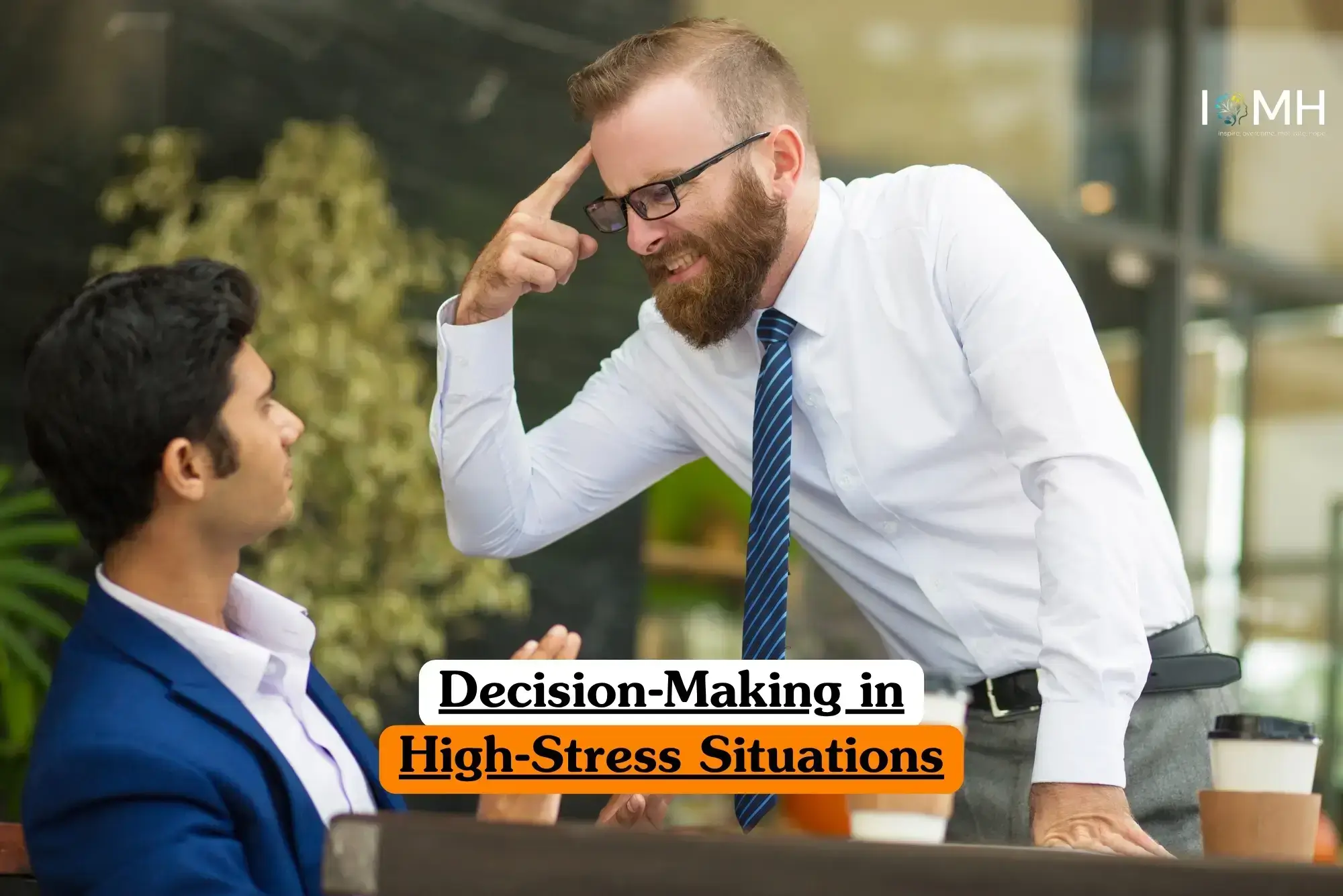 Decision-Making in High-Stress Situations course banner with two professionals in business setting one in white shirt and blue striped tie emphasizing point by gesturing to temple while other in blue suit listens attentively with coffee cups on table and greenery background.