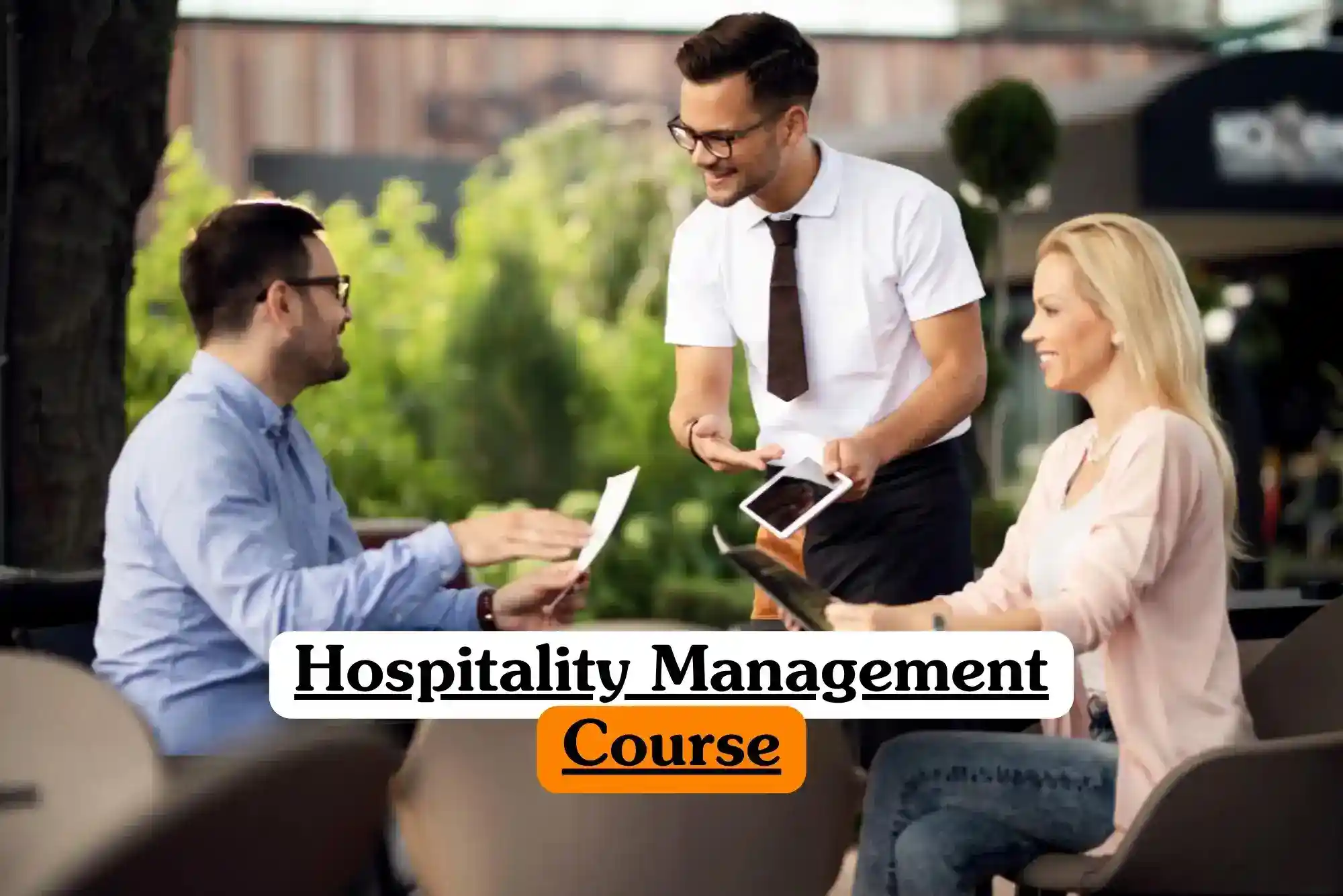 Hospitality Management Course banner with server in white shirt and dark tie holding tablet interacting with two seated individuals reviewing menus at outdoor café table surrounded by greenery and blurred architectural background professional customer service training setting.