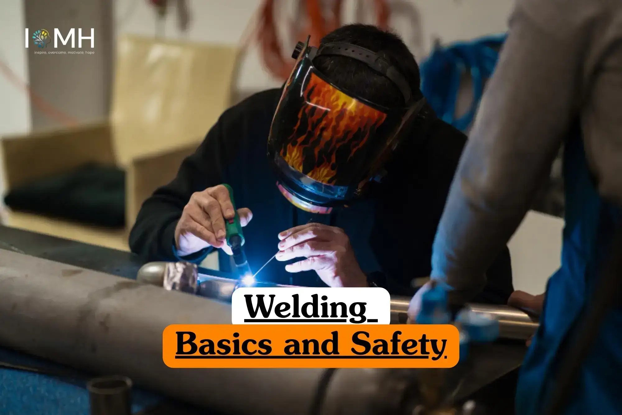 Welding Basics and Safety course banner with professional welding metal pipe using torch wearing flame helmet and IOMH logo.