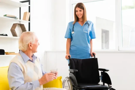 Care assistant providing elderly care in a UK residential setting, showcasing patient comfort and mobility support.