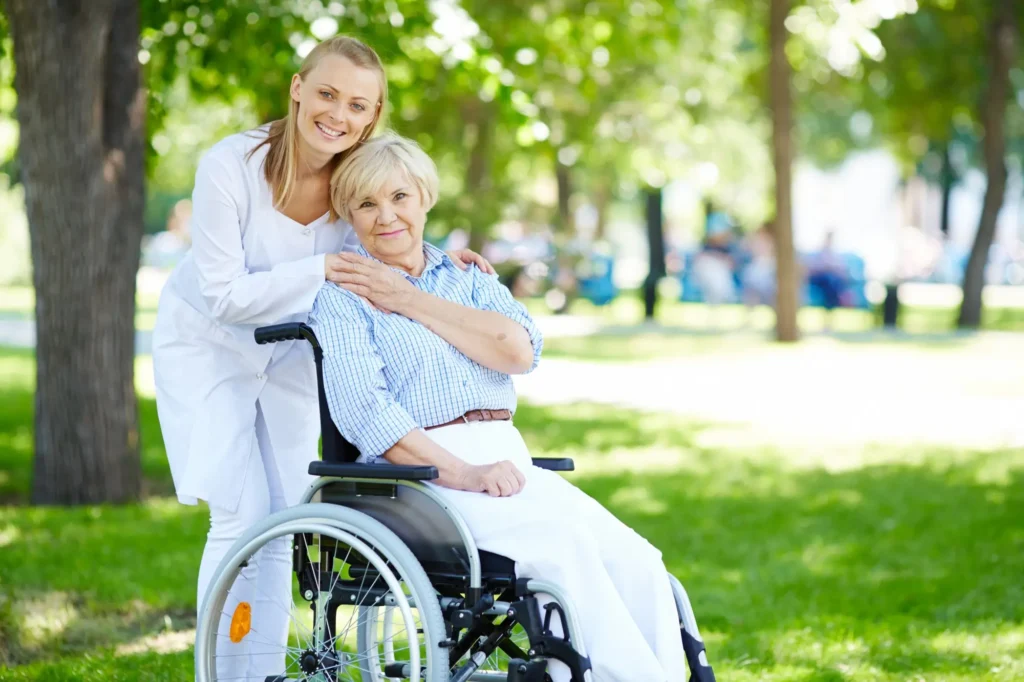 Nurse assisting senior patient in wheelchair – compassionate care and benefits of Level 3 Health and Social Care diploma