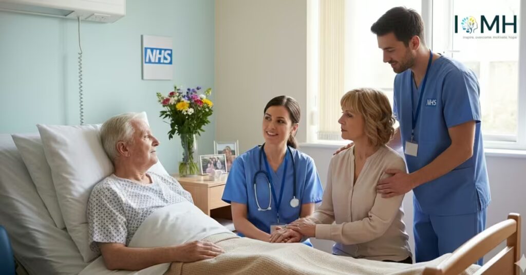 Elderly patient in NHS hospital room with staff and visitor offering emotional and medical support.