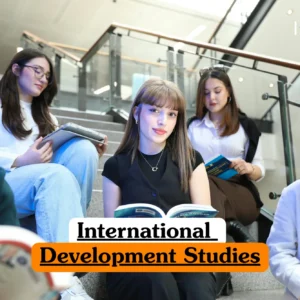 Theoretical global economics and social policy training banner featuring a diverse group of five young adult students sitting on indoor concrete stairs, actively reading books and using tablets in a modern educational facility.