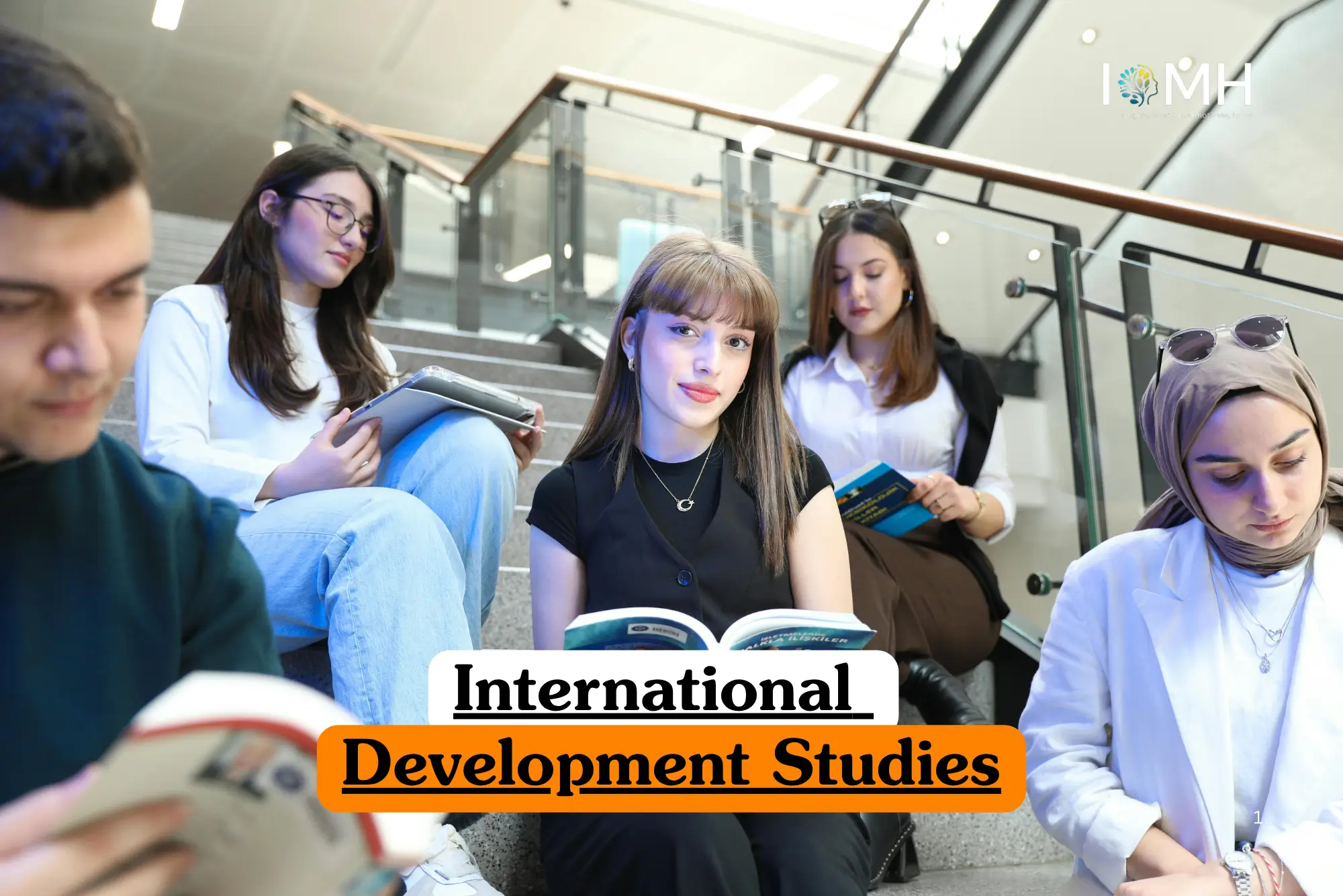 Theoretical global economics and social policy training banner featuring a diverse group of five young adult students sitting on indoor concrete stairs, actively reading books and using tablets in a modern educational facility.