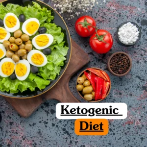 Nutrition and dietetics training banner featuring a flat-lay of keto-friendly foods, including a salad topped with boiled eggs and olives, fresh tomatoes, red peppers, and black peppercorns on a rustic grey surface.