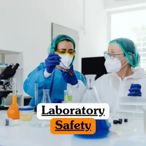 Science and safety training banner featuring two lab technicians in full protective gear, including hairnets, masks, and gloves, carefully inspecting a test tube in a clinical laboratory setting.