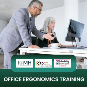 Office ergonomics training banner featuring a male supervisor in a grey suit leaning over a desk to assist a female colleague working at a computer in a modern, bright office space.