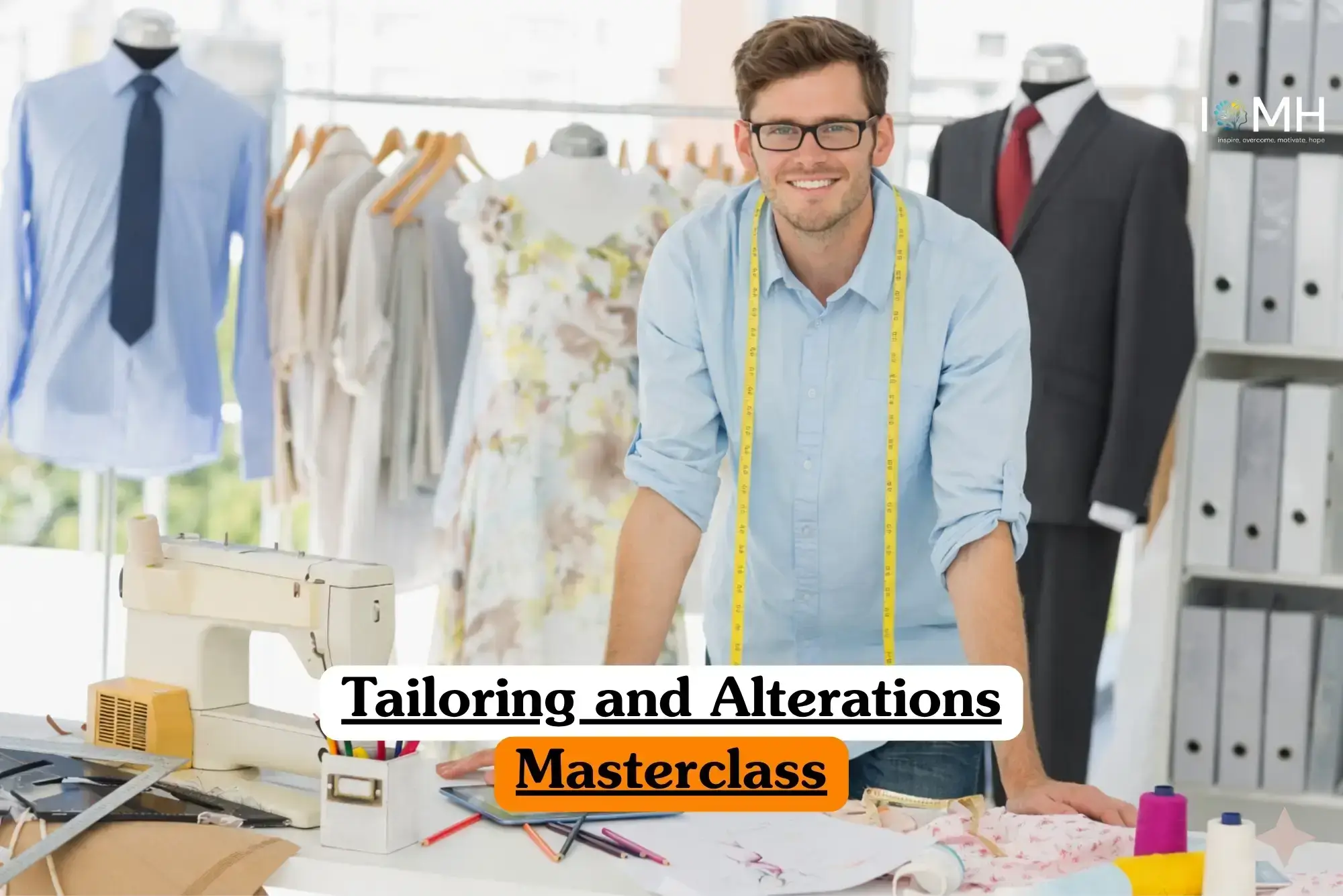 Tailoring and Alterations Masterclass course banner with tailor in light blue shirt glasses and yellow measuring tape around neck standing in professional studio with sewing machine fabric rulers colored pencils mannequins in garments clothes rack and binders on shelves..