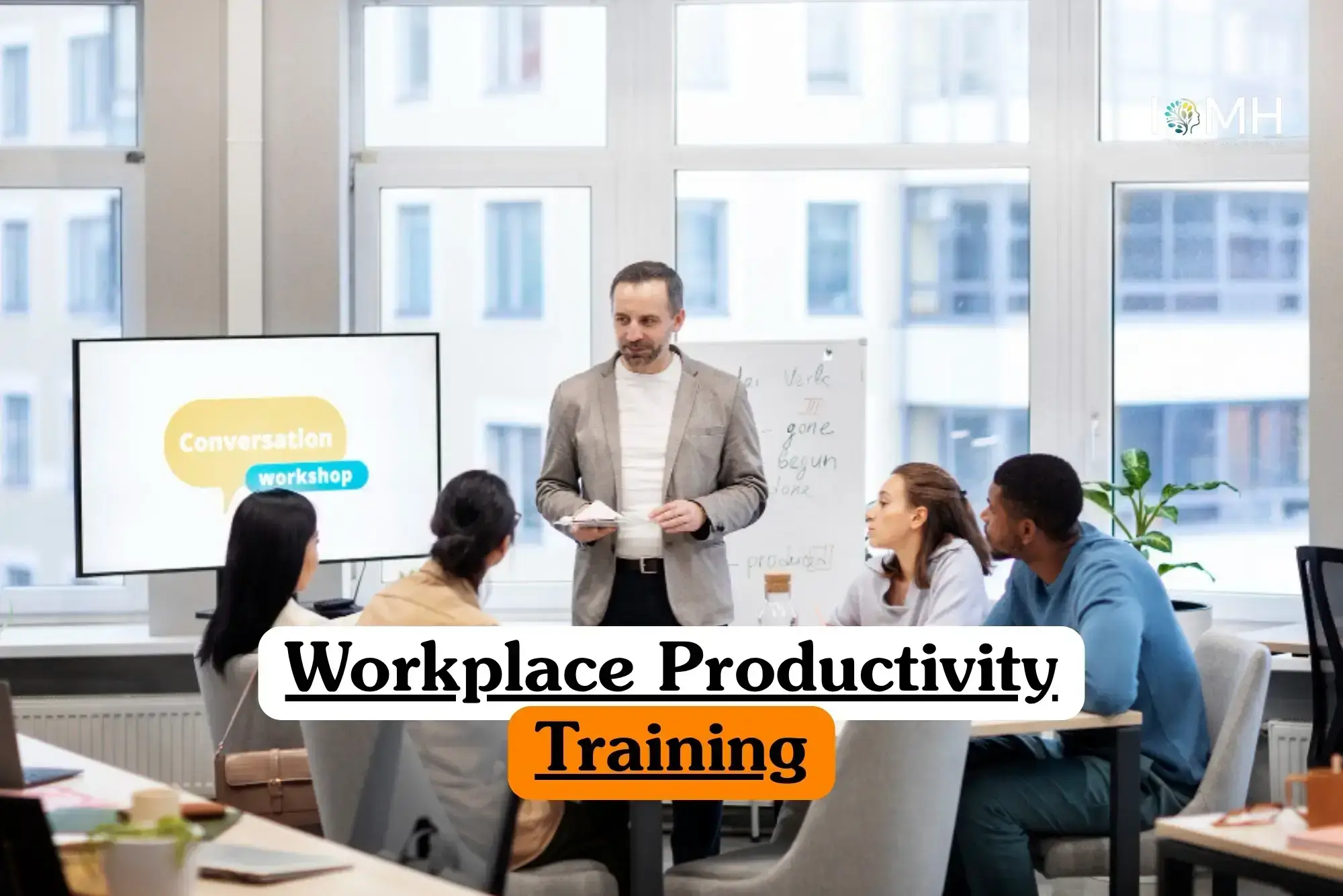 Workplace Productivity Training course banner with facilitator leading office workshop participants seated with whiteboard notes and screen display.