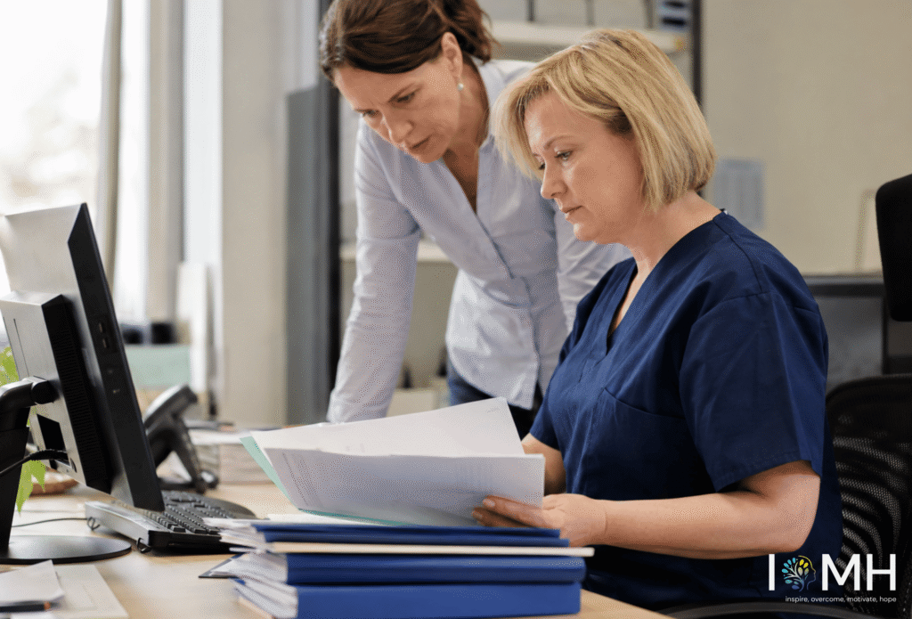 Healthcare staff reviewing clinical coding documents in an office setting