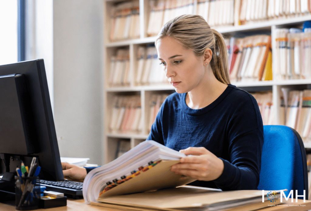 Clinical coding worker checking medical documents with attention to detail