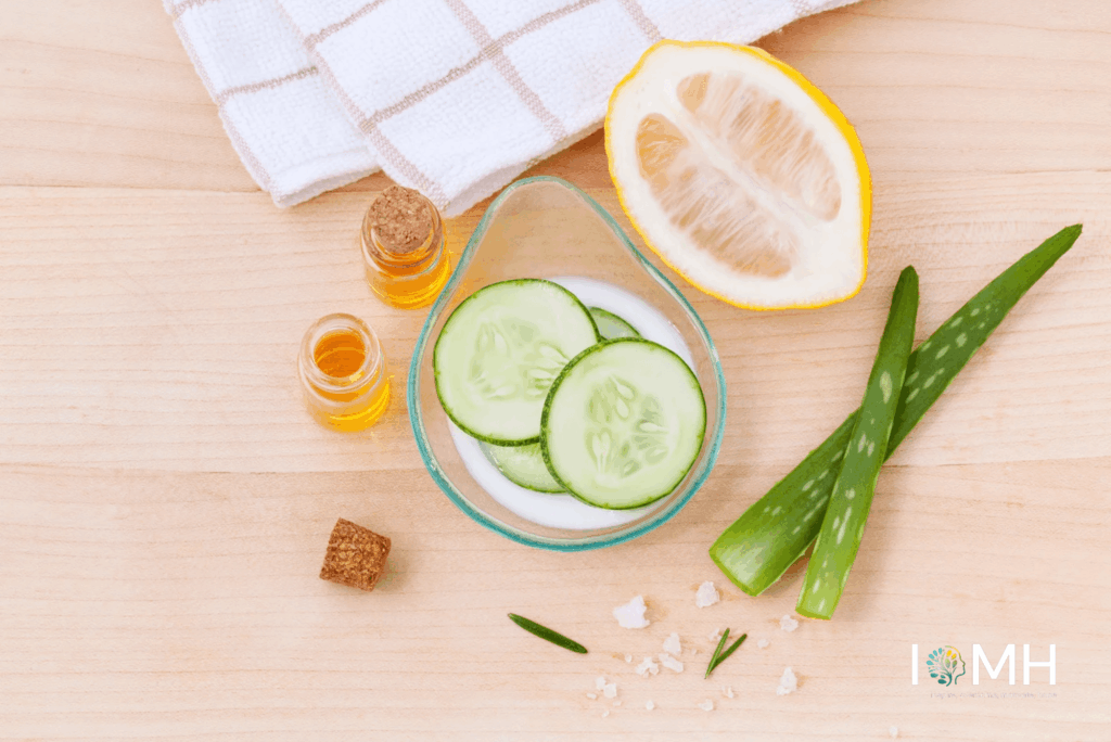 Natural skincare ingredients including cucumber slices, aloe vera, lemon, and essential oils arranged for a DIY healthy skin routine