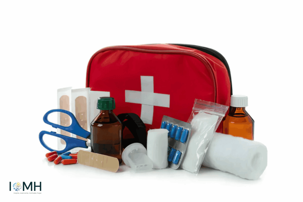Red first aid kit bag with white cross surrounded by medical supplies including scissors, bandages, pills, bottles and gauze – essential pregnancy emergency kit for expectant mothers